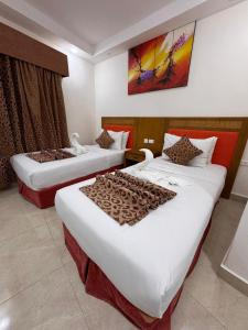 a hotel room with two beds in a room at Petra Rocks Hotel in Wadi Musa +24 photos
