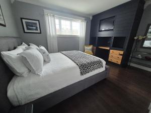 a bedroom with a bed and a television in it at The Blue Jay Nest in Topsail