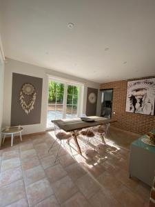 a living room with a table and chairs at A Chardonnerets by La Maison de Mel in Enghien
