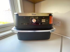 a toaster oven sitting on a counter next to a window at The Garden Room in Spittal