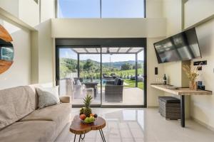 a living room with a couch and a table at Topaz Suites in Pefkohori