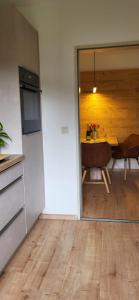 a kitchen with a table and a dining room at Ammergaufeeling mit einmaligem Bergblick, Terrasse, Nähe zur Nato Schule in Oberammergau +10 photos