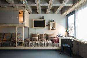 
a living room with a bed and a tv at Jam Hotel in Brussels
