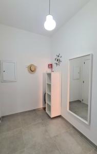 a room with a mirror and a pink cabinet at Lucy Apartment sul lungomare in Maiori
