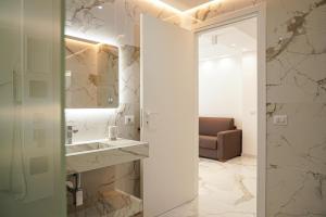 a bathroom with a sink and a mirror at Kind House in Pozzallo +30 photos