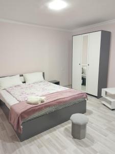 a bedroom with a large bed with a pink blanket at Lyucie Guest House Ijevan in Ijevan