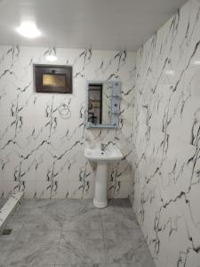 a white bathroom with a sink and a mirror at Lyucie Guest House Ijevan in Ijevan