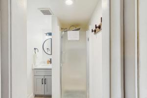 a bathroom with a shower and a sink at Winter Park Lodge II #104 in Fraser +11 photos