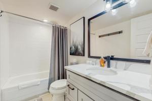 a bathroom with a sink and a toilet and a tub at Winter Park Lodge II #104 in Fraser +29 photos