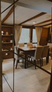 a dining room with a table and chairs at Vila Helena in Colići