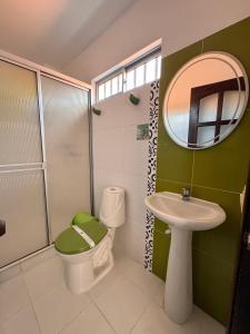 a bathroom with a toilet and a sink and a mirror at Hotel Premium BISS in Supía +41 photos