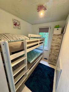 a room with two bunk beds and a window at Ferienhaus Haffschatz in Ueckermünde