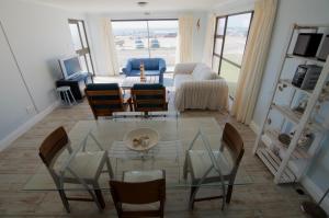 a living room with a glass table and chairs at Tassies in Gansbaai
