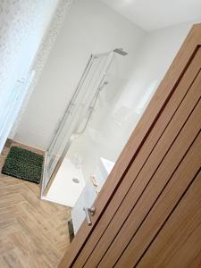 a glass door leading into a room with a floor at The Salt House in Amble