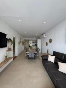 a living room with a couch and a table at Eucaliptus in Camarles