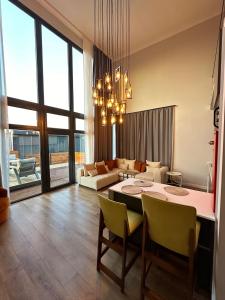 a living room with a table and chairs and a couch at Loft Sabırlı in Kaynarca +27 photos