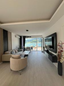a living room with a couch and a table at Royal Terrace Konjic in Železnička Stanica Ostrožac +14 photos