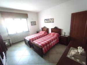 a bedroom with two beds and a window at La Mergozzina in Mergozzo