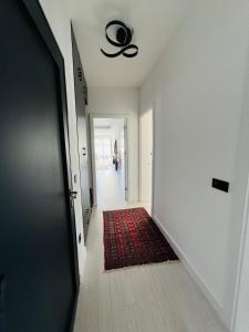a hallway with a ceiling fan and a red rug at Royal Terrace Konjic in Železnička Stanica Ostrožac
