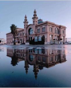 a large building with its reflection in the water at YOUR HOME 26 in Bari