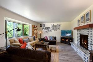 a living room with a couch and a fireplace at Sea Change by Paradise Retreats in Santa Barbara