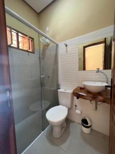 a bathroom with a toilet and a sink and a shower at Hotel do Carmo in Piracuruca +35 photos