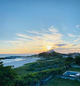 a view of the beach at sunset at Surf Zone Hostel in Saquarema