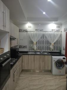 a kitchen with a sink and a washing machine at 3bdr Solar Power 24hrs plus Starlink Internet in Lusaka