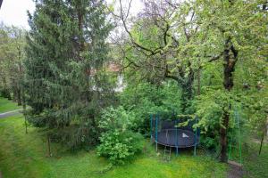 a blue table in the middle of a park with trees at Moderný byt v najlepšej lokalite in Nitra