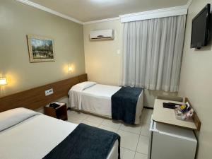 Postel nebo postele na pokoji v ubytování Cedro Hotel