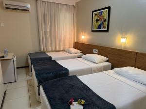 Postel nebo postele na pokoji v ubytování Cedro Hotel