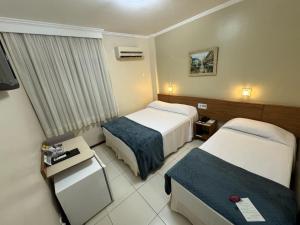 Postel nebo postele na pokoji v ubytování Cedro Hotel