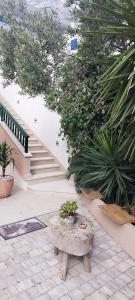 a patio with a table and some plants and stairs at House Lipo in Makarska