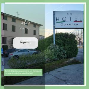 a sign for a hotel with a car parked in a parking lot at Hotel Cavezzo in Cavezzo