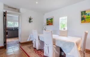 a white dining room with a table and chairs at Beautiful Home In Mougins in Mougins