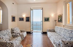 a living room with couches and a view of the ocean at 4 Bedroom Lovely Apartment In Camogli in Camogli