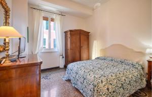 a bedroom with a bed and a dresser and a television at 4 Bedroom Lovely Apartment In Camogli in Camogli