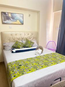 a bedroom with two beds in a room at Regal Suites in Athi River +25 photos