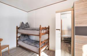 a room with two bunk beds and a tv at 1 Bedroom Lovely Apartment In Grado in Grado