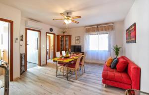 a living room with a red couch and a table at 1 Bedroom Lovely Apartment In Grado in Grado