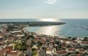 an aerial view of a city and the ocean at Stunning Apartment In Novalja With Wifi in Novalja +14 photos