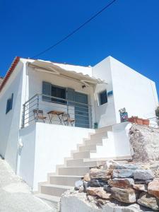 a white house with stairs in front of it at Nama Seaview Kokkari in Kokkari