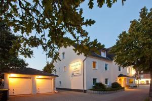 a large white building with two garage doors at Kocks Hotel Garni in Hamburg