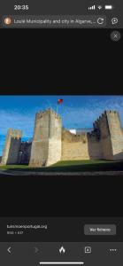 a picture of a castle with a flag on it at Marroquia in Loulé