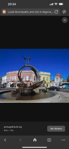 a picture of a statue in the middle of a city at Marroquia in Loulé