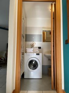 a washing machine in a bathroom with a sink at Appartamento Decanter in Tirano