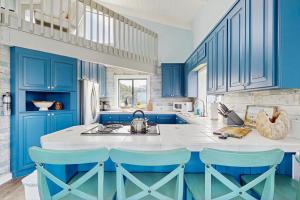 a blue and white kitchen with blue cabinets at Stella Del Mare in Fort Bragg
