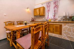 a kitchen with a wooden table and chairs at House Moj mir in Primošten