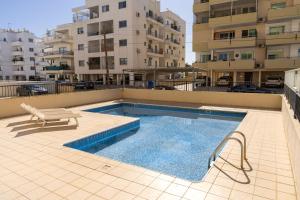 a swimming pool on the roof of a building at Olivia Mackenzie 2 Bedroom Flat with Pool in Larnaka