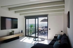 a living room with a couch and a table at Civico Savoia Apartment in Rosolini